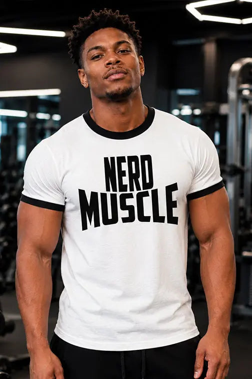 Man wearing a white t-shirt with 'NERD MUSCLE' text in a gym setting